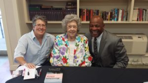 Northgate Terrace Senior Asset Manager Terri Evans (left) and KCDC Executive Director and CEO Alvin Nance (right) have their copies of “Mountain Glory” signed by author Margaret Bowling at a book signing at Northgate Terrace. 