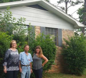 KCDC Section 8 Occupancy Coordinator Kim Trame (left) and KCDC Training Specialist Jennifer Bell (right) meet with veteran Dewey Snapp (center) to present the keys to his new home. 