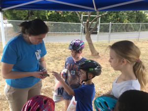 Zoo Knoxville’s Bethany Dunn allows Aiden Thornton to touch a lizard from their collection while Savannah Bradley and Ireland Hubbs look on at the second annual Western Heights Community Fair at Beaumont Magnet School on Oct. 13. 