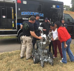Knoxville Police Department’s Jonathan Chadwell show Antwain Boudain, Demarcus Johnson and Beaumont Magnet School teacher Sabrina Johnson a demonstration of the bomb squad robot at the second annual Western Heights Community Fair at Beaumont Magnet School on Oct. 13. 