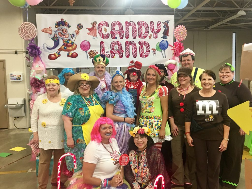 Knoxville’s Community Development Corporation (KCDC) finance, human resources and purchasing departments pose in costume by their Candy Land-themed booth, which was unanimously voted first place in the costume and decorating contest, at KCDC’s Annual Chili Cook-off benefiting United Way of Greater Knoxville on Oct. 21. Pictured from left to right are (front row) Kelia West, Elaine Natividad (second row) Denise Jaqua-Houston, Karen Newsome, Shauba Lawson, Candy Miles, Wendy McGlasson, Carolyn Collins (back row) Alena Reeves, Terry McKee, Bob Justice, Matt Alvantas, Randall Brown and Denise Campbell. 