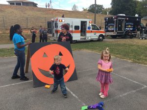 Zachariah Varner (left) and Jennaleigh Akin (right) play a fall-themed game organized by Endasia Pucket (back left) and Kayla Harris (back right) of the Boys & Girls Clubs Moses Teen Center at the second annual Western Heights Community Fair at Beaumont Magnet School on Oct. 13. 