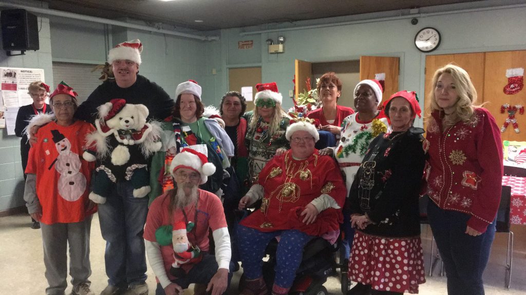 Love Towers residents compete in the tacky Christmas sweater contest at the annual Christmas Bingo Blitz at Love Towers on Dec. 19.